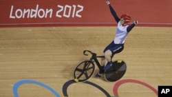 Britain's Jason Kenny celebrates after winning the gold medal in the track cycling men's sprint event, during the 2012 Summer Olympics in London, Monday, Aug. 6, 2012.