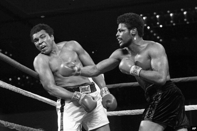 In this 1978, file photo, Leon Spinks, right, throws a punch at Muhammad Ali during their championship fight in Las Vegas. (AP Photo/File)