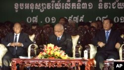 Chea Sim, center, president of the ruling Cambodian People's Party, Hun Sen, right, the party's vice president and also Cambodian prime minister, and Heng Samrin, left, the party's honorary president, sit as the country marks Khmer Rouge downfall in 1979,