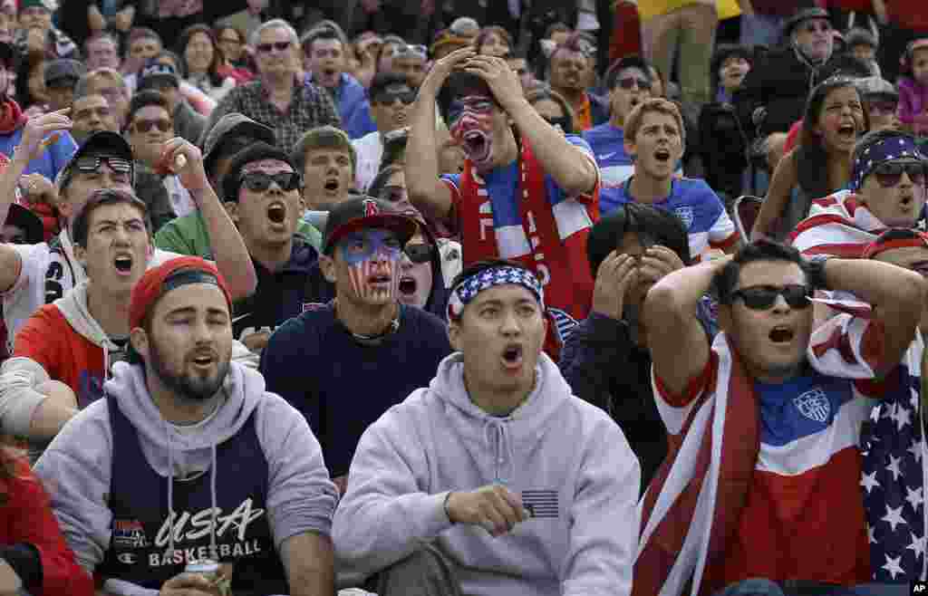 Alex Dubin, 17, center top, reacts with other U.S. fans while watching the 2014 World Cup soccer match between the United States and Germany at a public viewing party in San Francisco. 