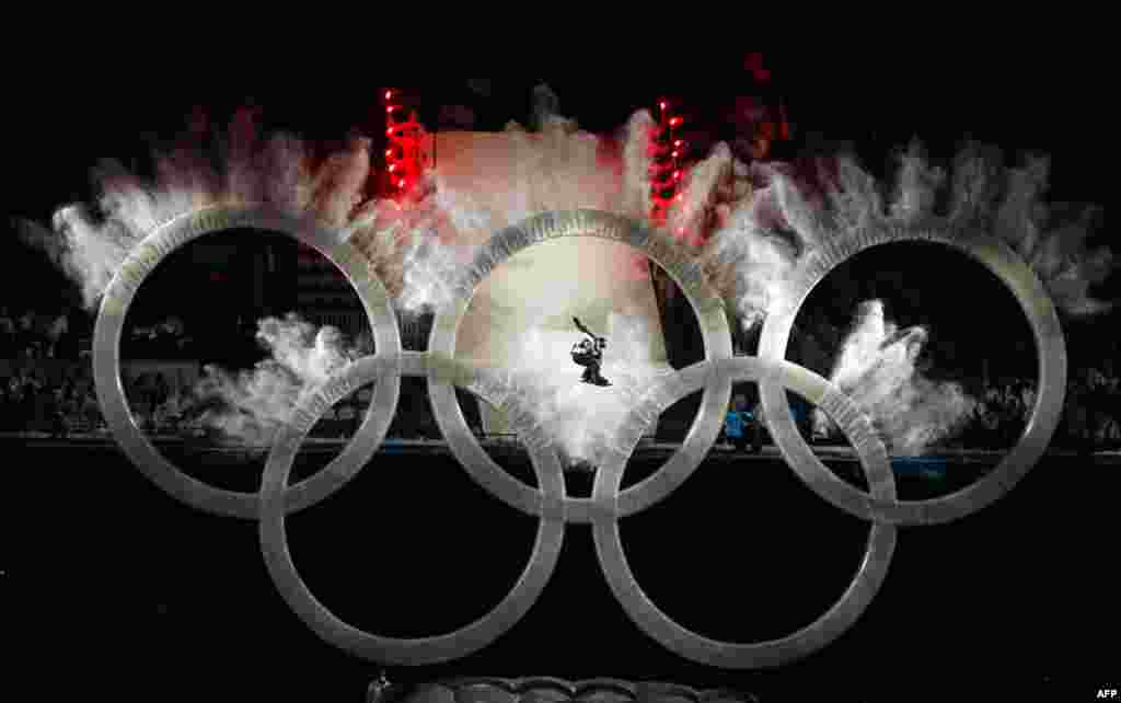 February 12: A snowboarder soars through the centre ring of the Olympic Rings during the opening ceremony of the Vancouver 2010 Winter Olympics. (Mike Blake/Reuters)