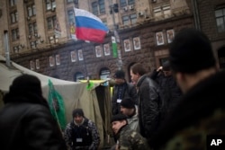 A Russian flag waves on a tent set by anti-Yanukovych protesters in Kiev's Independence Square, the epicenter of the country's current unrest, Ukraine, Saturday, March 1, 2014.