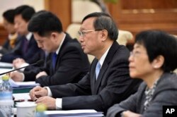 Chinese State Councilor Yang Jiechi, second from right, addresses a speaks a representative of the European Union for Foreign Affairs and Security Policy, during a meeting in Beijing, April 19, 2017.