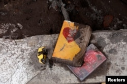 Books and a toy lie on the ground at a house affected by the eruption of the Fuego volcano in San Miguel Los Lotes in Escuintla, Guatemala, June 8, 2018.