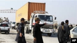 Pakistani security personnel stop truck carrying supplies for NATO forces in neighboring Afghanistan at Takhtabeg check post in Pakistani tribal area of Khyber, Pakistan, on their way to Torkham border post on Saturday, November 26, 2011.