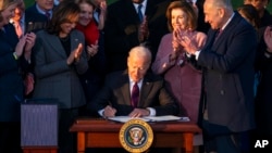 President Joe Biden signs the "Infrastructure Investment and Jobs Act" during an event on the South Lawn of the White House, Nov. 15, 2021.