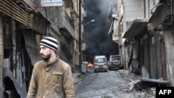 FRILE - A Syrian man walks through the former rebel-held Salaheddin district in the northern Syrian city of Aleppo.