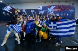 Fans wave flags before the Eurovision Song Contest 2017 Grand Final at the International Exhibition Center in Kyiv, Ukraine, May 13, 2017.