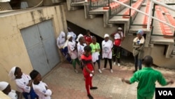 Coach Stanley Uka talks to his players after their scoreless game at the tournament. (VOA / C. Oduah)