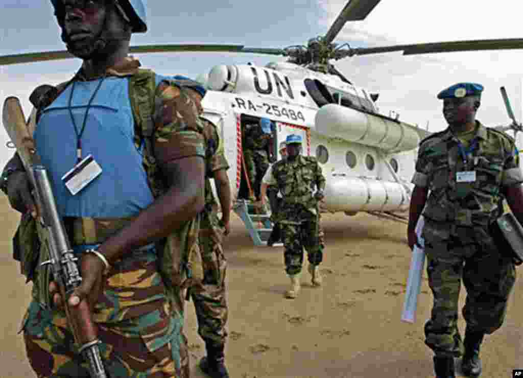 In a photograph made available by Albany Associates, General Martin Luther Agwai (centre) Force Commander of the United Nations-African Union Mission in Darfur (UNAMID), disembarks from a UN helicopter, Monday, July 21, 2008, during a visit to Shangil Tob