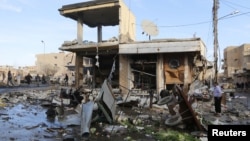 A site hit by what activists said were airstrikes by forces loyal to Syria's President Bashar al-Assad is pictured in Raqqa, Syria, Nov. 25, 2014. 