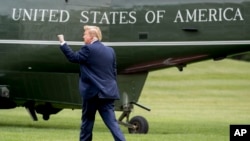 FILE - President Donald Trump walks on the South Lawn of the White House in Washington, May 8, 2019, to board Marine One.