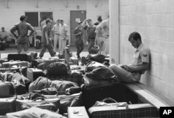 An American soldier reads a paperback book while waiting to leave Vietnam along with the last remaining U.S. military personnel in 1973.