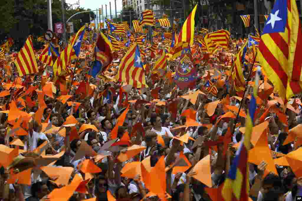 People wave pro-independence Catalan flags, known as the Estelada flag, during a rally calling for the independence of Catalonia, in Barcelona, Spain. Separatists have used Catalan National Day for years to rally hundreds of thousands of people in Barcelona to call for the creation of a new Mediterranean nation. 