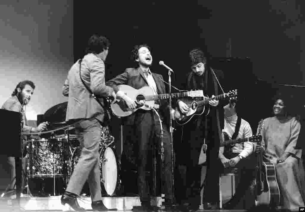 Folk singer Bob Dylan, center, performs with drummer Levon Helm, left, Rick Danko, second left, and Robbie Robertson of The Band at Carnegie Hall in New York City on Jan. 20, 1968. 