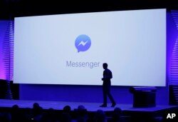 David Marcus, Facebook Vice President of Messaging Products, watches a display showing new features of Messenger during the keynote address at the F8 Facebook Developer Conference in San Francisco.
