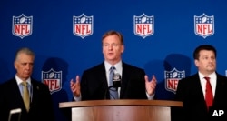 NFL commissioner Roger Goodell, center, is flanked by Pittsburgh Steelers president Art Rooney II, left, and Arizona Cardinals owner Michael Bidwill during a news conference where he announced that NFL team owners have reached agreement on a new league policy that requires players to stand for the national anthem or remain in the locker room, during the NFL owner's spring meeting, May 23, 2018, in Atlanta.