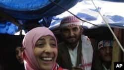 Yemeni activist Tawakkul Karman, one of the three recipients of the 2011 Nobel Peace Prize, reacts as she receives congratulations from protestors at her tent in Change Square in Sanaa, Yemen, Saturday, Oct. 8, 2011.