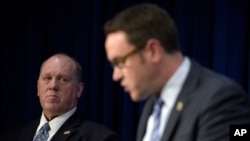 U.S. Immigration and Customs Enforcement acting director Thomas Homan, left, listens as Homeland Security Investigations deputy executive associate director Derek Benner speaks during a news conference in Washington, May 11, 2017.