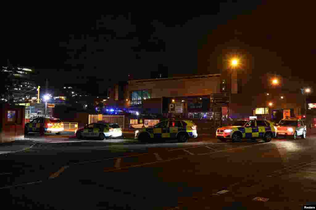 Police vehicles are seen outside the Manchester Arena, where U.S. singer Ariana Grande had been performing in Manchester, northern England, Britain, May 23, 2017. 