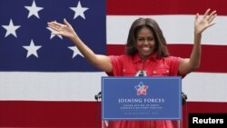 U.S. first lady Michelle Obama gestures during her visit to the U.S. Army Garrison at Vicenza, northern Italy, June 19, 2015.