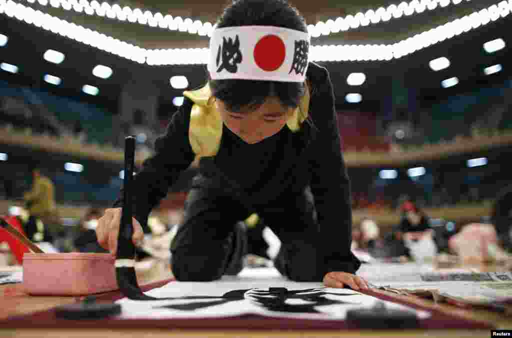 A Japanese girl participates in a calligraphy contest to celebrate the New Year in Tokyo, Japan.