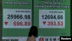 A panel displaying the closing Hang Seng Index and Hang Seng China Enterprise Index are shown outside a bank in Hong Kong, China, June 29, 2015.
