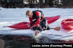 Gerrit Egnew collects a water sample in winter for Adventure Scientists' Microplastics project. Photo by Louise Johns