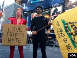 Lucinda Aragon (left), dressed in a costume with a Donald Trump mask, said she thinks the Republican candidate's policies are divisive, and she said she is supporting Hillary Clinton, in Times Square, New York, Nov. 8, 2016. (R. Taylor/VOA)