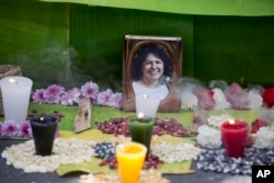 FILE - A picture of Berta Caceres sits on an altar in her honor during a demonstration outside Honduras' embassy in Mexico City, June 15, 2016.