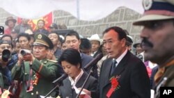 Chairman of Tibet Autonomous Region Qiangba Puncog, second right, speaks on the Chinese side at a ceremony to open the Nathu La Pass, in northeastern Indian state of Sikkim, Thursday, July 6, 2006. Indian and Chinese officials reopened a famed Silk Road pass high in the Himalayas 44 years after it was shut by war, in a ceremony Thursday marked by brass bands that sent festive notes swirling into mountain mists. (AP Photo/Gurinder Osan)