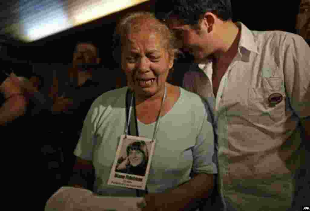 The relative of a victim killed during Argentina's dirty war cries at the end of the trial of former dictator Jorge Videla in Cordoba, Argentina, Wednesday Dec. 22, 2010. Videla was sentenced to life in prison Wednesday for the torture and murder of 31 p