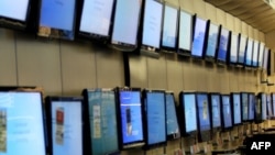 FILE - Flat-screen TV sets on display at a Best Buy store in San Francisco, California. 