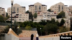 A couple walk in the Israeli settlement of Maale Edumim, in the occupied West Bank, Dec. 24, 2016.