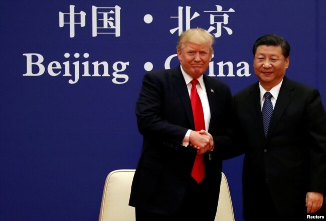 FILE - U.S. President Donald Trump and China's President Xi Jinping meet at the Great Hall of the People in Beijing, Nov. 9, 2017.
