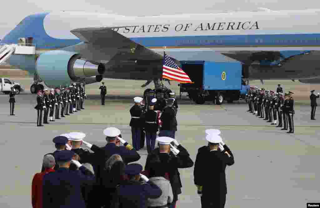 A U.S. military honor guard carries the flag-draped casket of former President George H.W. Bush to &quot;Special Air Mission 41,&quot; one of the Air Force One planes flown by President Bush when he was in office, to depart Washington for further services and burial in Texas from Joint Base Andrews, Maryland, Dec. 5, 2018.