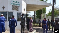 Security men stand guard at the parliament gate in Abuja, Nigeria. Thursday, Nov. 20, 2014.