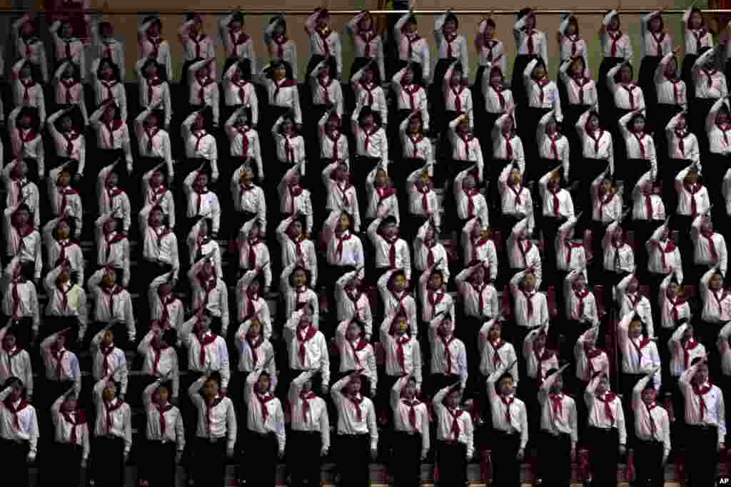 Rows of North Korean children stand and salute at a sports arena in Pyongyang for a national meeting of the Children&#39;s Union. 