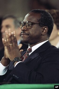 FILE - Judge Clarence Thomas pauses during testimony before the Senate Judiciary Committee on Capitol Hill in Washington, Oct. 11, 1991. A calm and resolute Thomas categorically denied Anita Hill's accusations of sexual harassment and told a tense session of the committee, "confirm me if you want," but that "no job is worth" what he has been through.