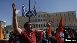 A municipality worker shouts slogans in front of the parliament during a rally against new austerity measures in Athens, October 3, 2012. 