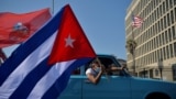 Cubans drive past the US embassy during a rally calling for the end of the US blockade against Cuba, in Havana, March 28, 2021 