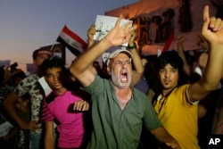 Iraqi protesters chant slogans demanding services and jobs during a demonstration in Tahrir Square, Baghdad, Iraq, July 14, 2018.