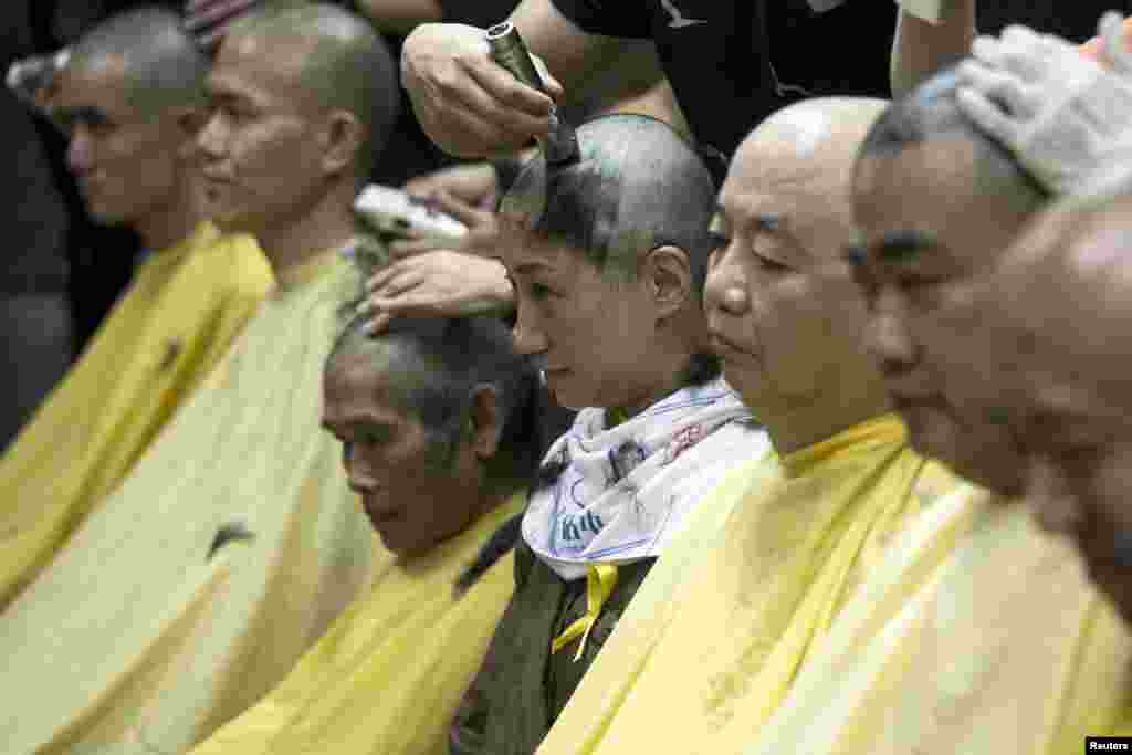 Former Civic Party lawmaker Tanya Chan (C) shaves her head during a protest to call for people to join the &quot;Occupy Central&quot; movement rally in Hong Kong, China.