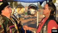 U.S. Marine Corps veteran Antonio Quezada, White Mountain Apache, receives spiritual cleansing and prayer from Native American Veterans Association (NAVA) Spiritual Advisor and Sun Walker, Tony Littlehawk, a member of the Cherokee tribe and an Army Vietna