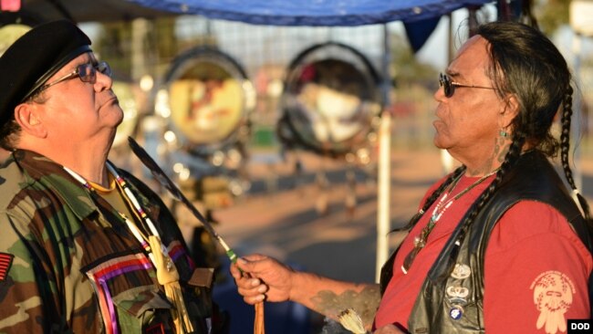 U.S. Marine Corps veteran Antonio Quezada, White Mountain Apache, receives spiritual cleansing and prayer from Native American Veterans Association (NAVA) Spiritual Advisor and Sun Walker, Tony Littlehawk, a member of the Cherokee tribe and an Army Vietna