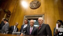 FILE - Senate Foreign Relations Committee Chairman Sen. Bob Corker, R-Tenn., center, speaks with the committee's ranking member Sen. Ben Cardin, D-Md., on Capitol Hill in Washington, April 14, 2015.