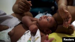 Gustavo Henrique who is 2-months old and born with microcephaly, reacts to stimulus during an evaluation session with a physiotherapist at the Altino Ventura rehabilitation center in Recife, Brazil, Feb. 11, 2016. 