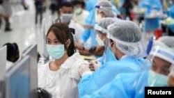 A person receives China's Sinovac coronavirus disease (COVID-19) vaccine at the Central Vaccination Center, inside the Bang Sue Grand Station, in Bangkok, Thailand, May 24, 2021. REUTERS