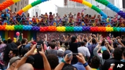 Revelers dance during the annual Gay Pride Parade in Sao Paulo, Brazil, Sunday, May 29, 2016. 