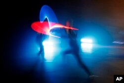 In this Feb. 10, 2019, photo, competitors battle during a national lightsaber tournament in Beaumont-sur-Oise, north of Paris. The French fencing federation has officially recognized lightsaber dueling as a competitive sport.